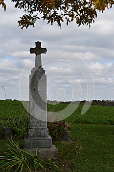 1800`s single cross gravestone in a country graveyard