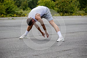 A 19 Year Old Teenage Boy Stretching In A Public Park