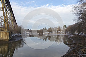 The 1908 railway trestle bridge and the 1859 St-FÃ©lix-de-Valois Church with their reflection in the Cap-Rouge River