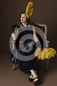 A 1920s woman wearing an evening dress with a gold headband and feathers