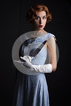 1930`s woman in blue dress holding a knife