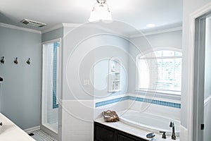 1950`s style bathroom with tile floor and dark brown cabinets in white and blue accents