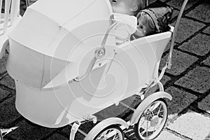1950s style stroller with doll in black and white