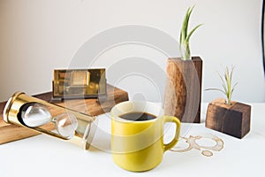 1970s still life with pyrex mug and hourglass