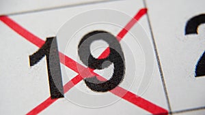 The 19st number in the calendar is crossed out with a red cross in a macro on a white sheet. Calendar for plans, notes