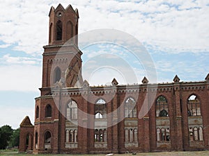 19th century ruined Lutheran church in Gothic style in former German canton of Saratov region against blue sky. Concept -