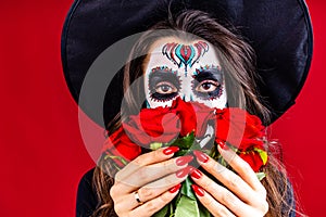 1st and 2nd november celebration of day of the dead in mexico concept woman with grimm skull face and black cloth in