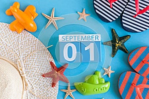 1st September. Image of september 1, calendar on blue summer background with beach vacation accessories. Back to school