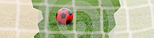 1x4 banner for website and social networks with soccer ball on a football field through a goal net