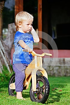 2 - 3 years joyful child riding a wooden balance bike