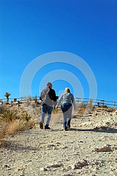 2 adults walking up a path