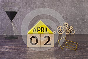 2 April on wooden grey cubes. Calendar cube date 02 April. Concept of date. Copy space for text or event