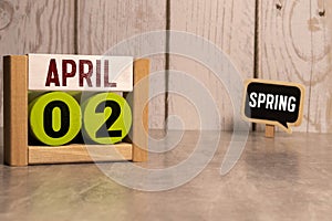 2 April on wooden grey cubes. Calendar cube date 02 April. Concept of date. Copy space for text or event
