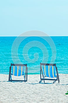 2 beach chairs on the beach at the sea