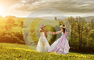 2 beautiful bride in the morning , the idyllic meadow , friendship symbol