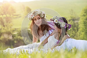 2 Beautiful bride in the outdoor, sitting on the grass - idyllic