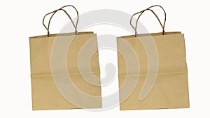 2 brown recyclable paper bags separated on a white