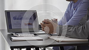 2 business people looking at financial charts in notebooks cheerful man analyzing Work in the office Gadgets and documents with gr