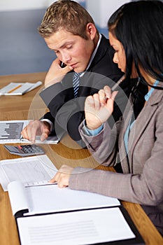 2 business people working on some calculations photo