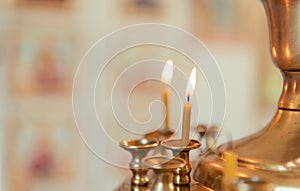 2 candles in an Orthodox church on a light