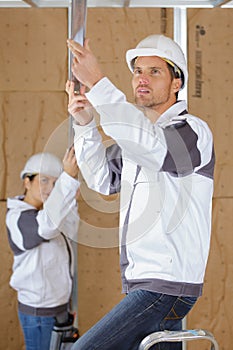 2 carpenters working indoors at construction site