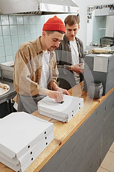 2 chefs prepare italian food for delivery today