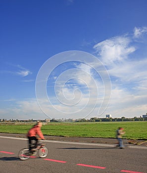 2 children playing with a bike and a toy scooter