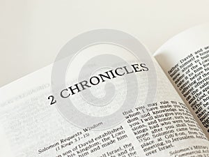 2 Chronicles open Holy Bible Book on white background. A close-up