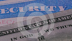 2 close up social security cards ssn cash US dollar bills money