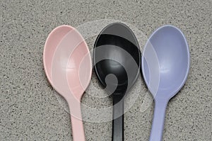 2 colored melamine spoons heads