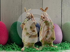 2 crafty standing eggshape bunnies, with babies, with fairy village painted on egg belly EASTER