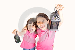 2 Cute Happy young girls celebrating Ramadan with their lanterns