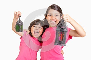 2 Cute Happy young girls celebrating Ramadan with their lanterns