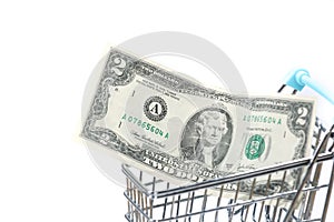 2 dollar banknote in a blue shopping cart isolated on a white background. Financial crisis. Lack of money. Digital banking.