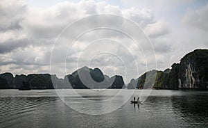 2 fishermen are fishing in halong bay, Quang Ninh Province, Vietnam