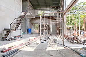 The 2 floors house under the construction has a steel ladder, scaffold and steel bar on the ground