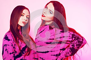 2 girls in the same things with bright makeup. Brunette girls, sisters, girlfriends, twins. Women`s power, March 8, Women`s Day.