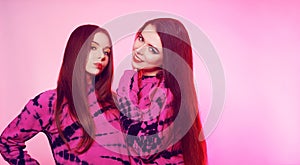 2 girls in the same things with bright makeup. Brunette girls, sisters, girlfriends, twins. Women`s power, March 8, Women`s Day.