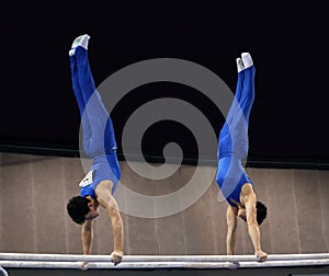 2 gymnasts on parallel bars