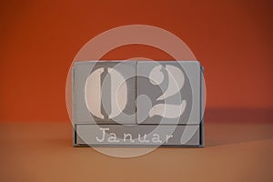 2 Januar on wooden grey cubes. Calendar cube date 02 January. Concept of date. Copy space for text. Educational cubes