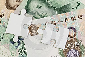 2 jigsaw puzzle on Chinese Yuan banknotes using as China economics, tariff or trade war negotiation future direction between the