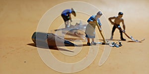 2 man and 1 woman cleaning trash from pencil sharpener with negative space