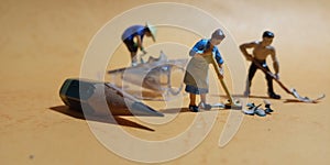 2 man and 1 woman cleaning trash from pencil sharpener with negative space