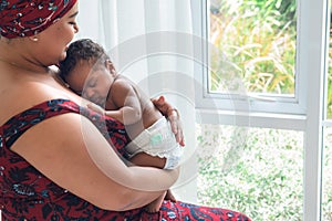 2-month-old baby newborn son, sleeping and happiness with his mother being held