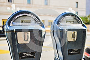 2 Parking Meters with a blurred street background