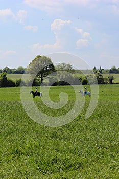 2 people horse riding in the English countryside