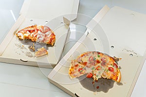 2 pizza boxs with a pieces of pizza on Brunch time.