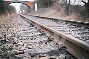 2 Railroad tracks lead towards a bridge