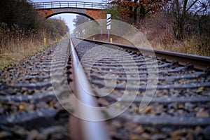 2 Railroad tracks lead towards a bridge