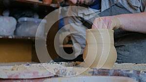 2 shots. Professional male potter making pot in pottery workshop